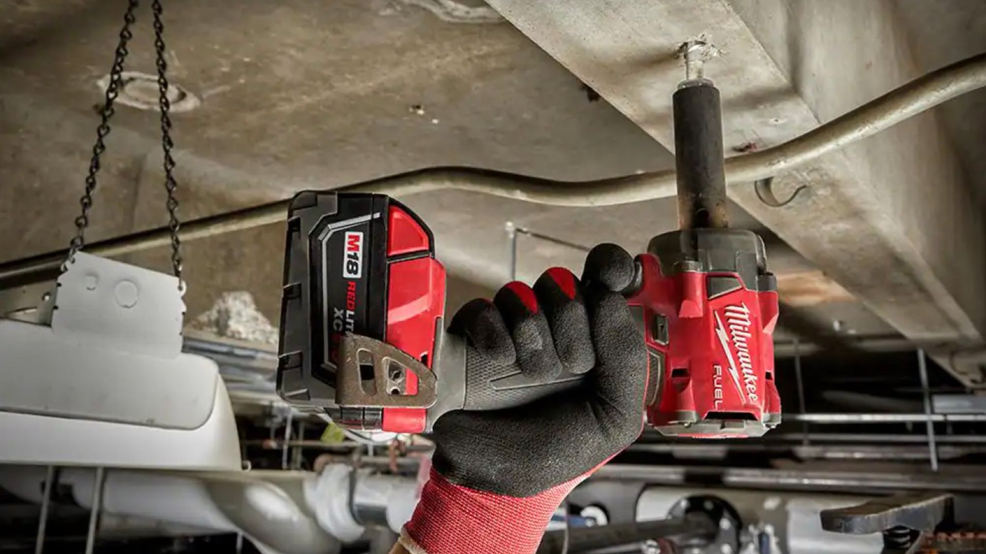 Milwaukee impact wrench being used by a man.