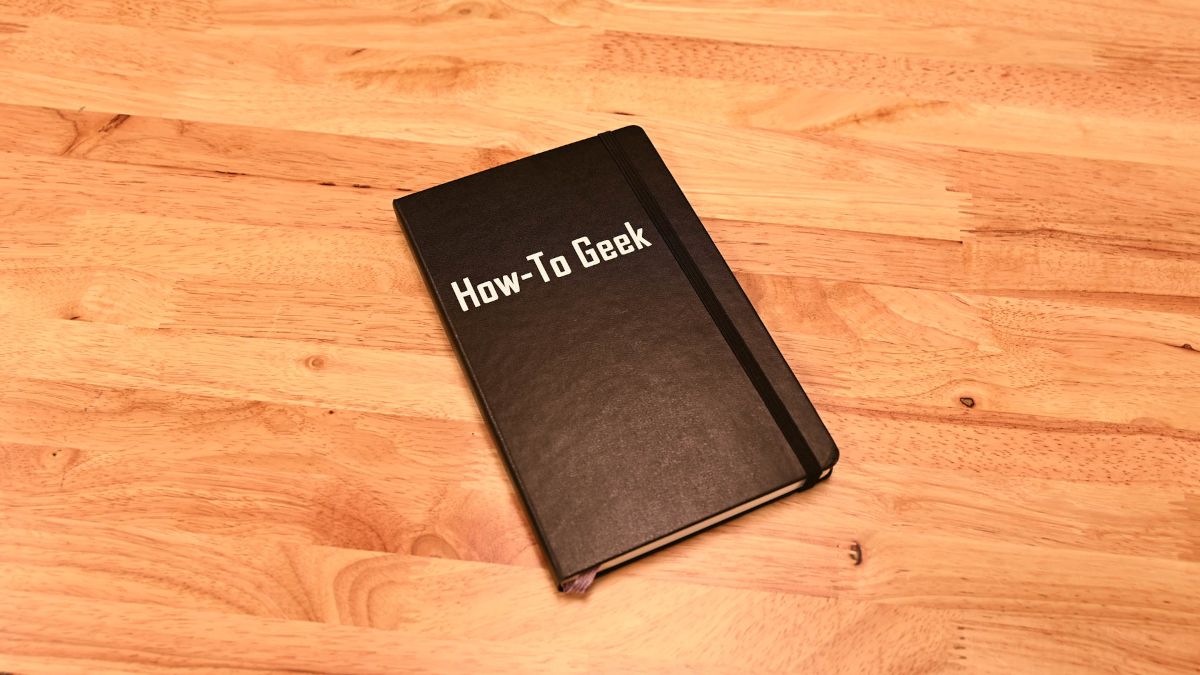 A How-To Geek notebook on a desk