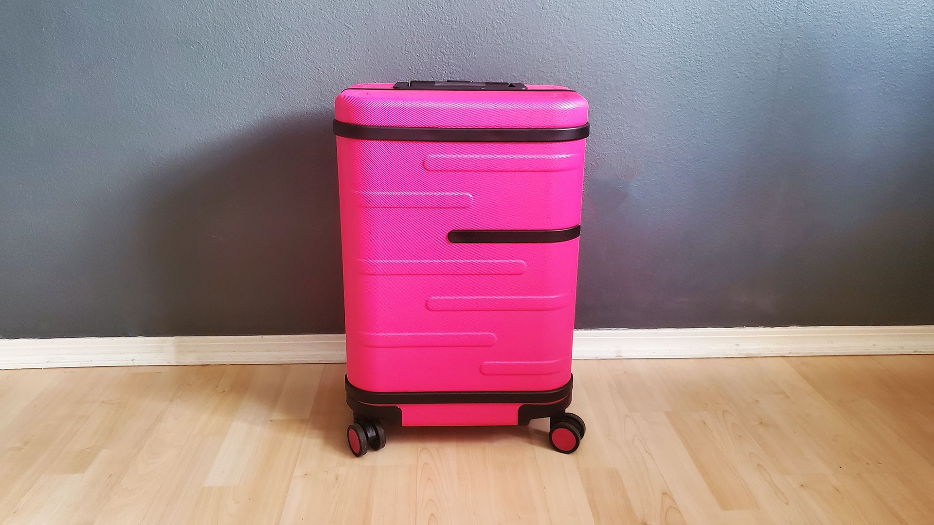 The T-Mobile Samsara Un-carrier On smart suitcase with its handle down.