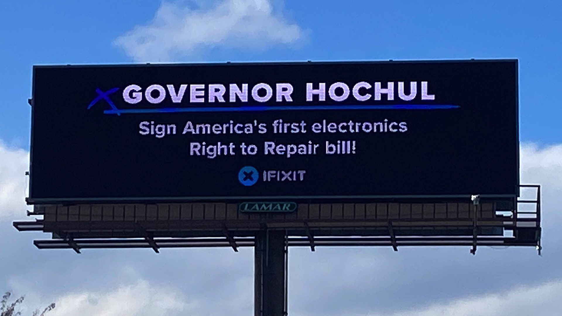 A photo of an iFixit-sponsored billboard encouraging Governor Hochul to sign the Digital Fair Repair Act