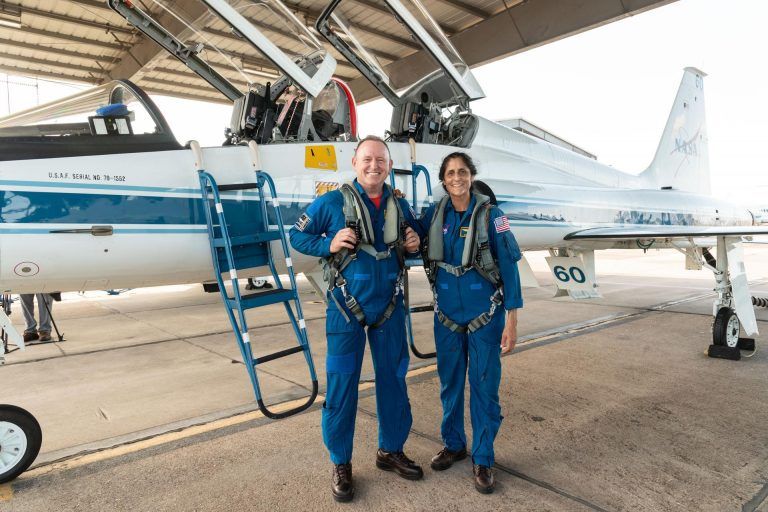 Photo of Barry “Butch” Wilmore and Sunita “Suni” Williams in front of a plane