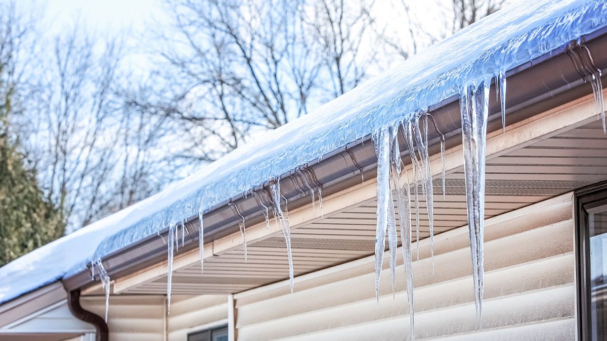 An ice dam built up along the gutter of a home.