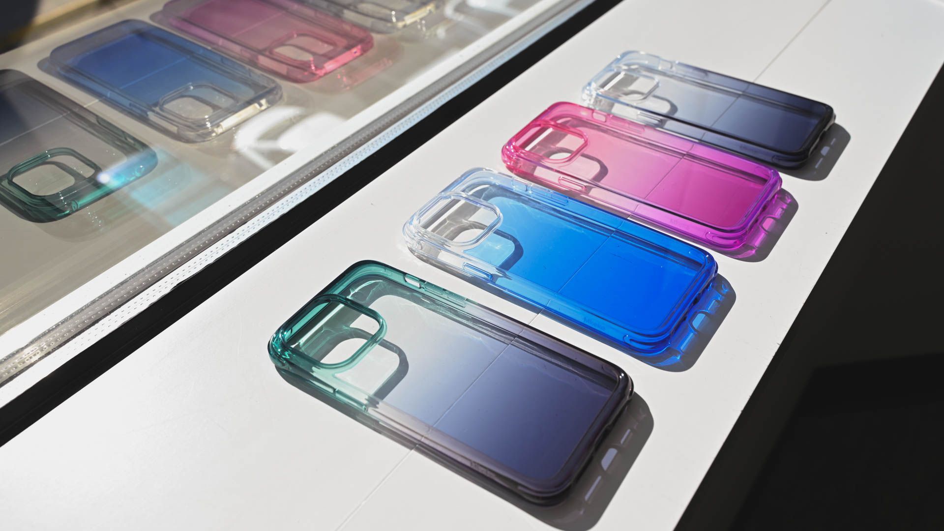 Colorful Mkeke clear iPhone 14 Pro cases lying on a table