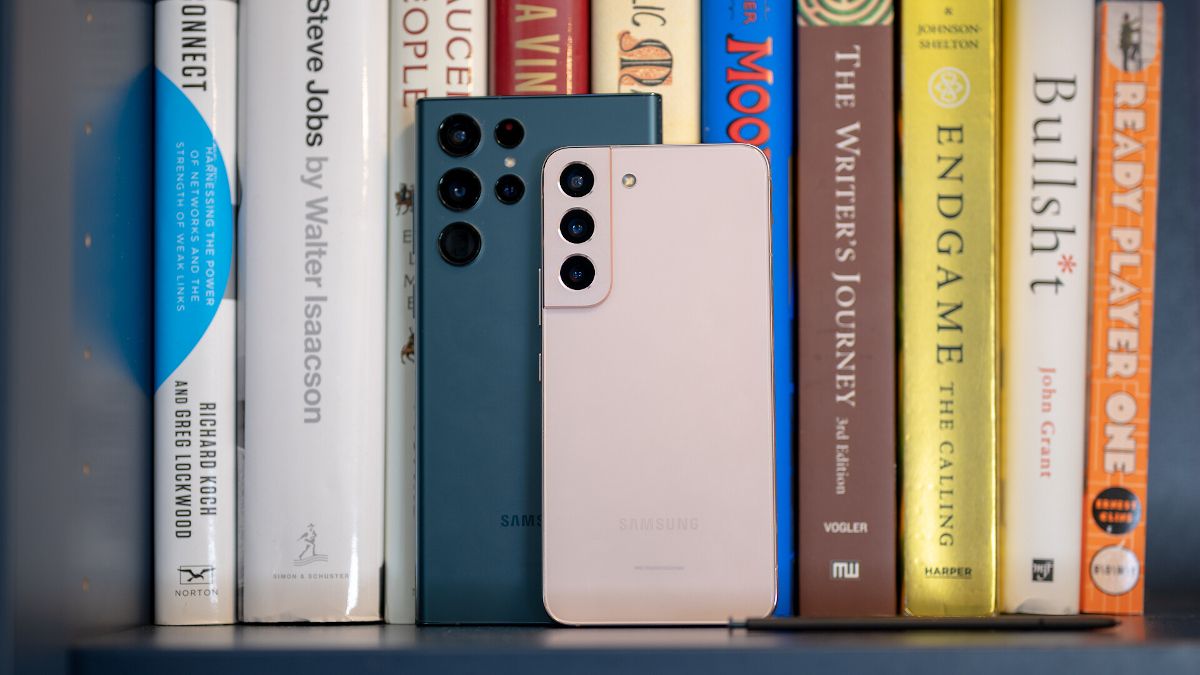 Samsung Galaxy phones on bookshelf.