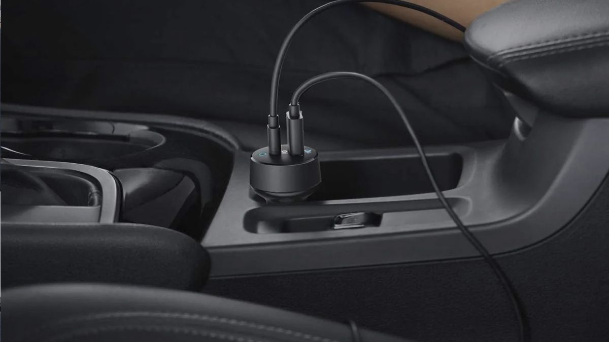 An Anker USB charger plugged into a car's 12 volt port.