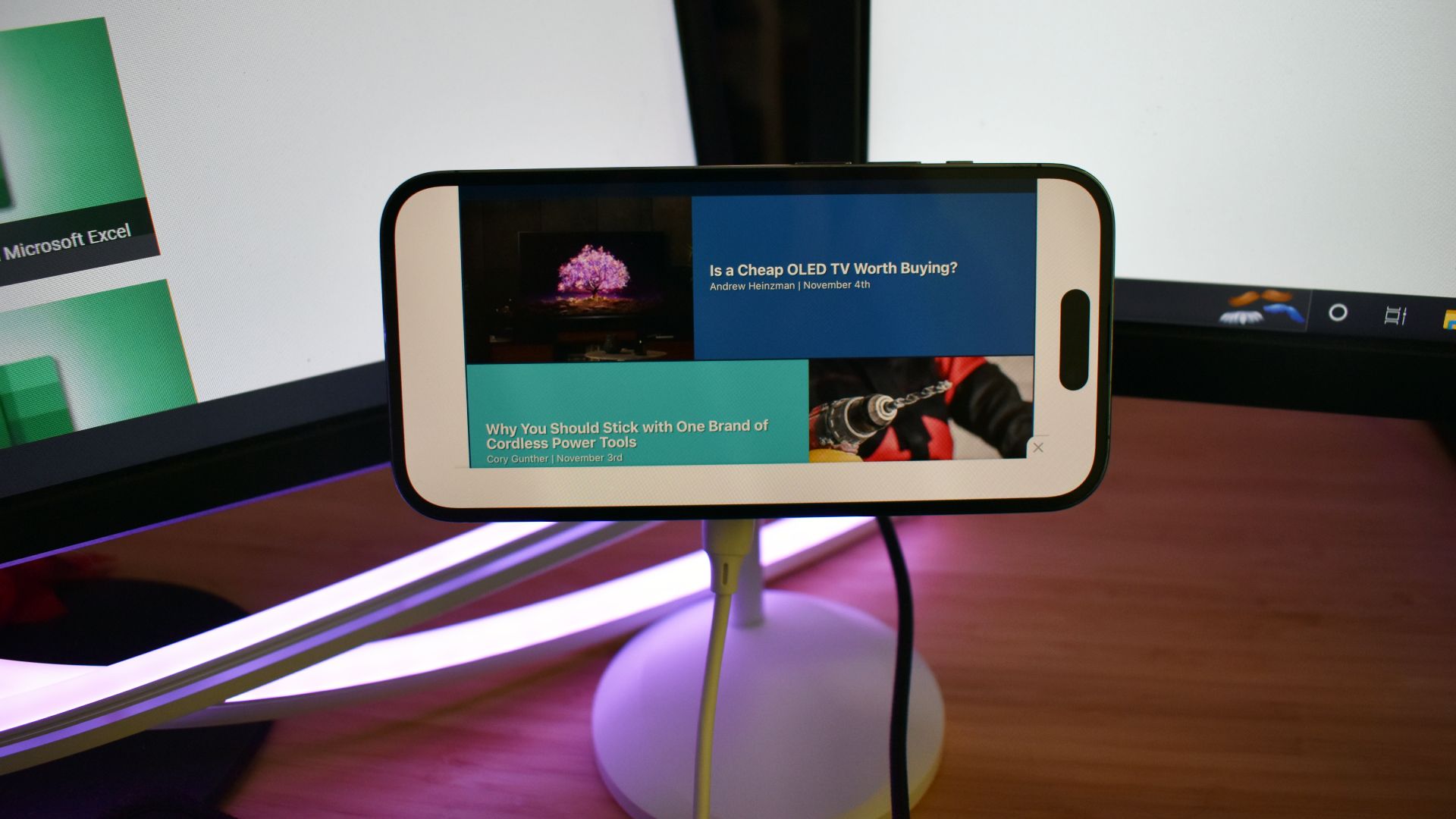 ESR HaloLock Shift wireless charger with iPhone in landscape mode on desk