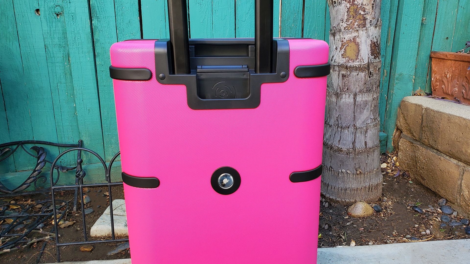 The T-Mobile Samsara Un-carrier On smart suitcase standing outdoors.