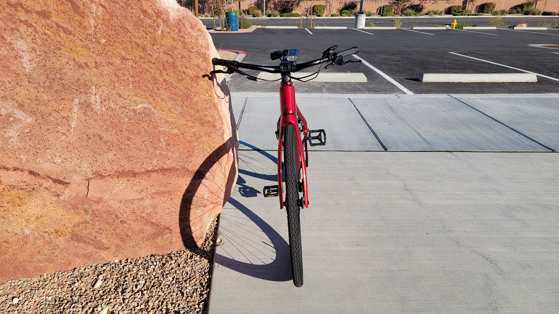 Superstrata ebike leaning on a rock at the park