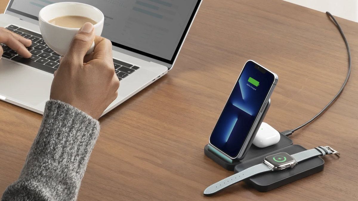 A wireless charging station with an iPhone, AirPods, and Apple Watch charging.