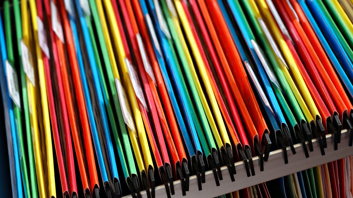 Colorful file folders in a cabinet drawer.