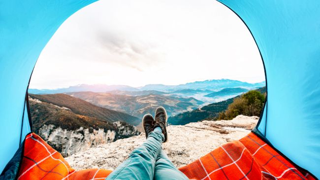 Point-of-view shot of a mountain view from within a tent.