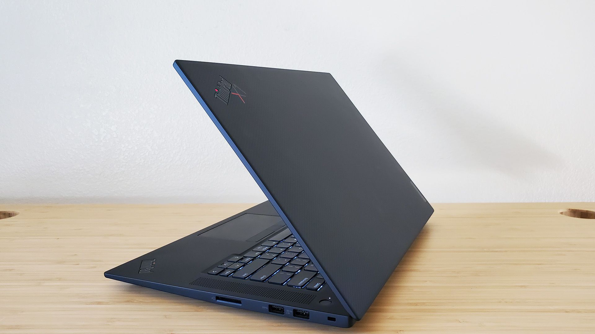 The Lenovo ThinkPad X1 Extreme Gen 5 laptop sitting open on a desk.