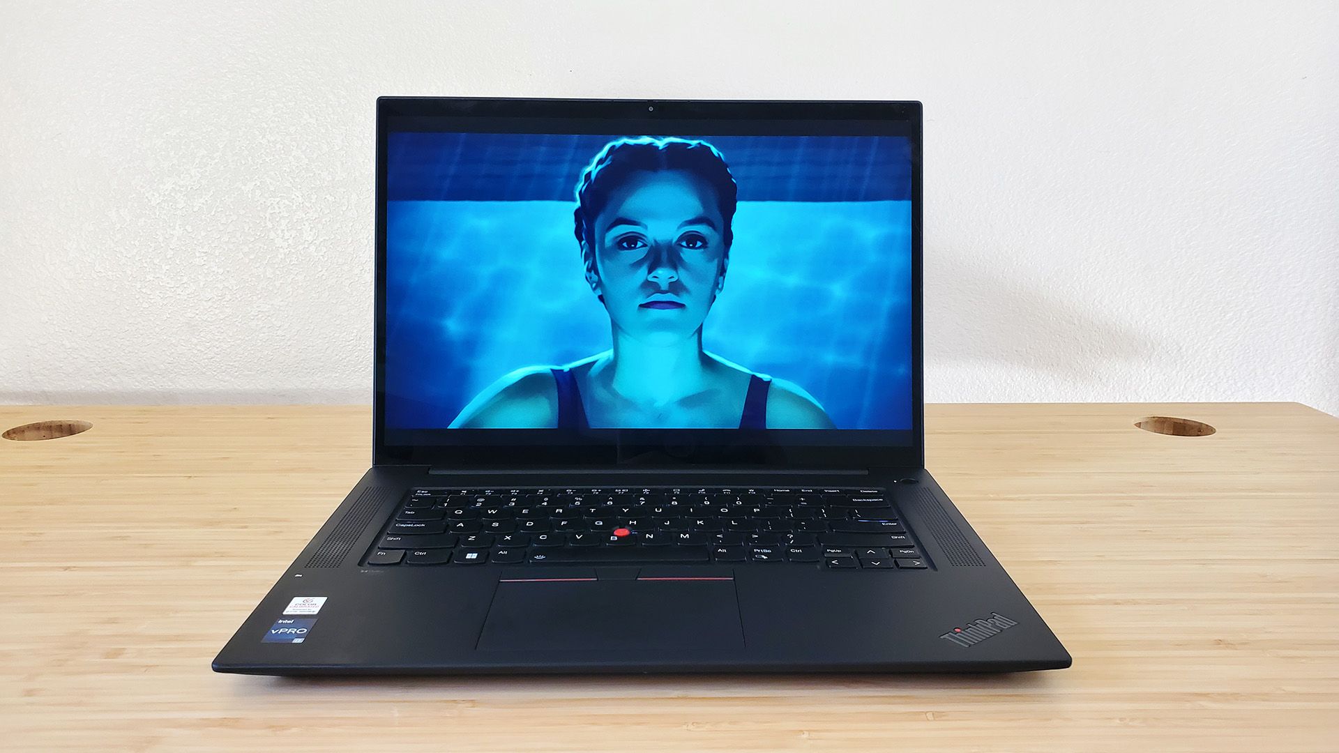 The Lenovo ThinkPad X1 Extreme Gen 5 laptop sitting on a desk playing a video game intro.