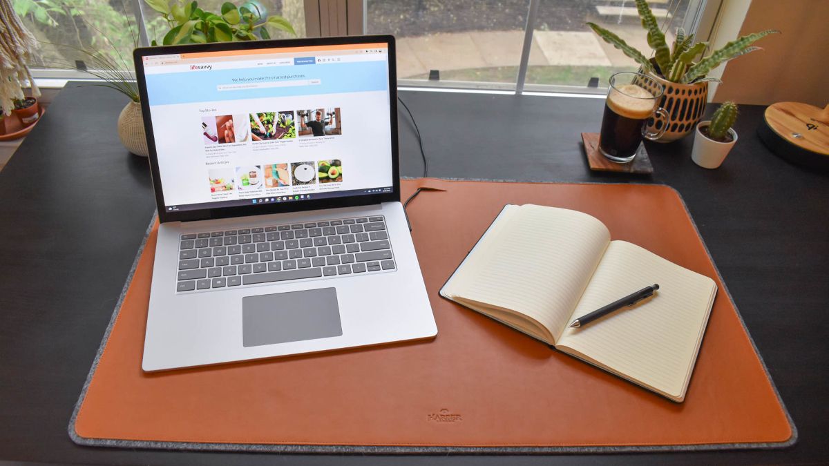 Laptop and notebook on the Harber London Leather Desk Mat.