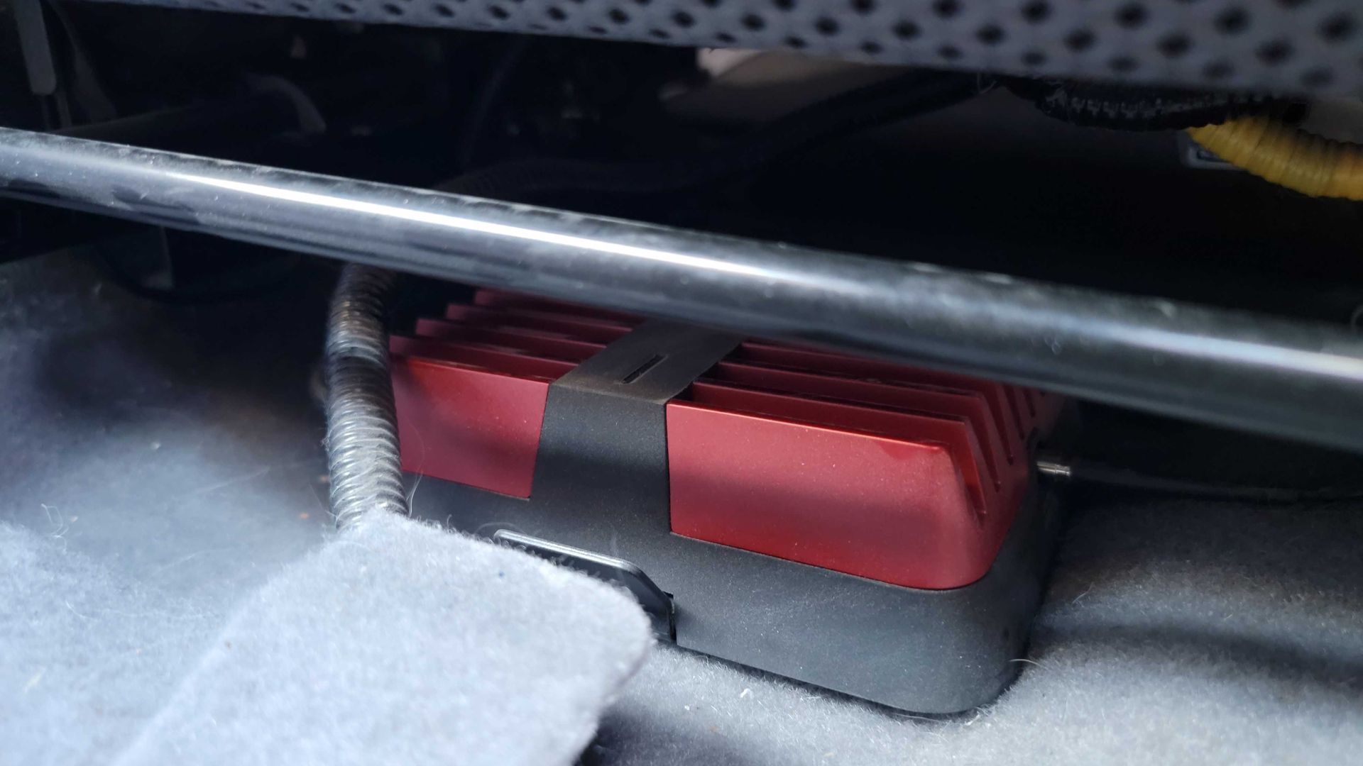 Weboost mounted under a car seat.