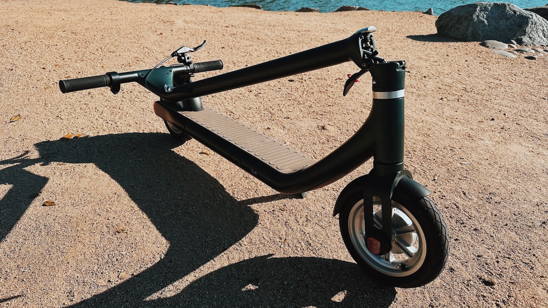 The Atomi Alpha scooter can fold and lock into place for carrying.