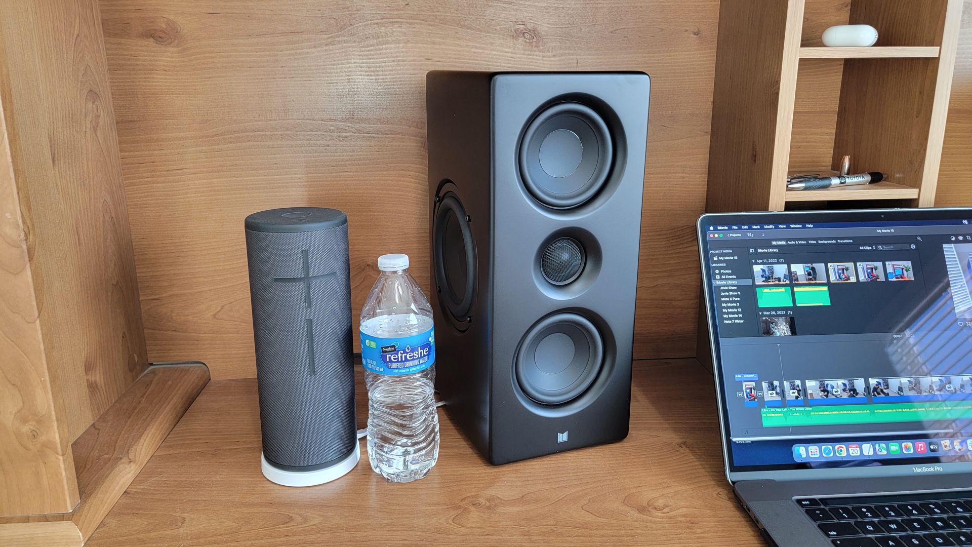 Monolith speaker next to a water bottle for size.
