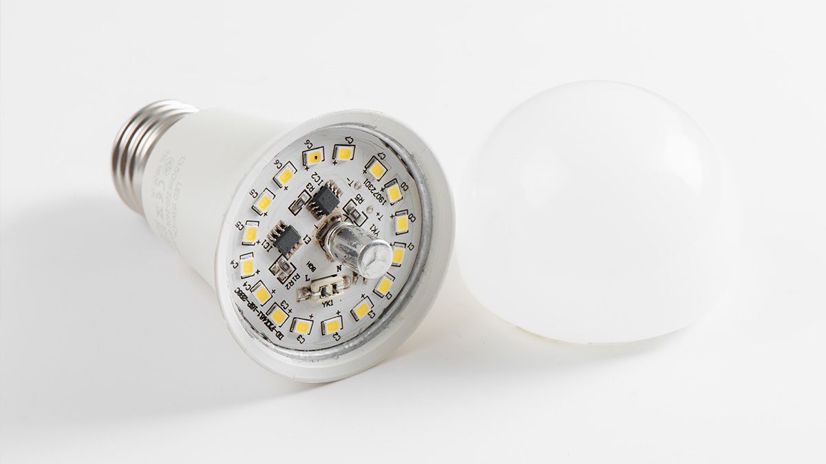 The inside of an LED bulb showing the circuit board and capactior.
