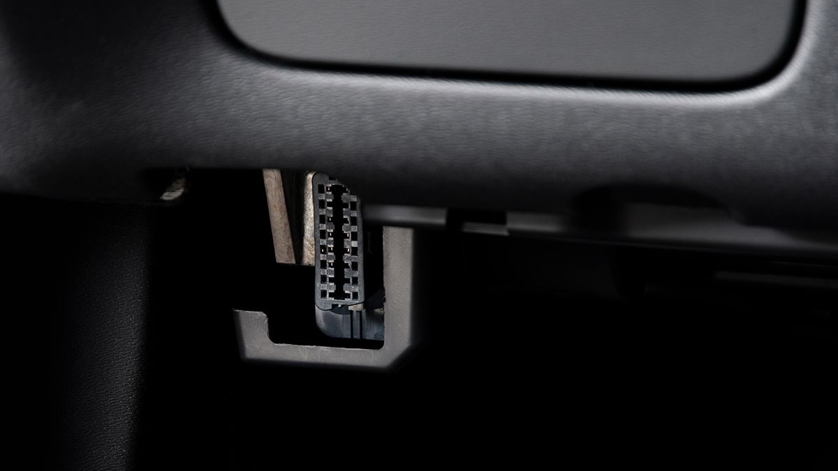 An ODB diagnostic port, visible under the front console of a vehicle.