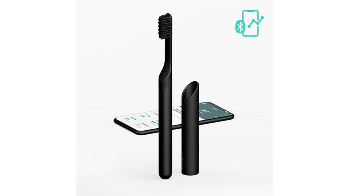 Quip Smart Electric Toothbrush with holder and iPhone in background