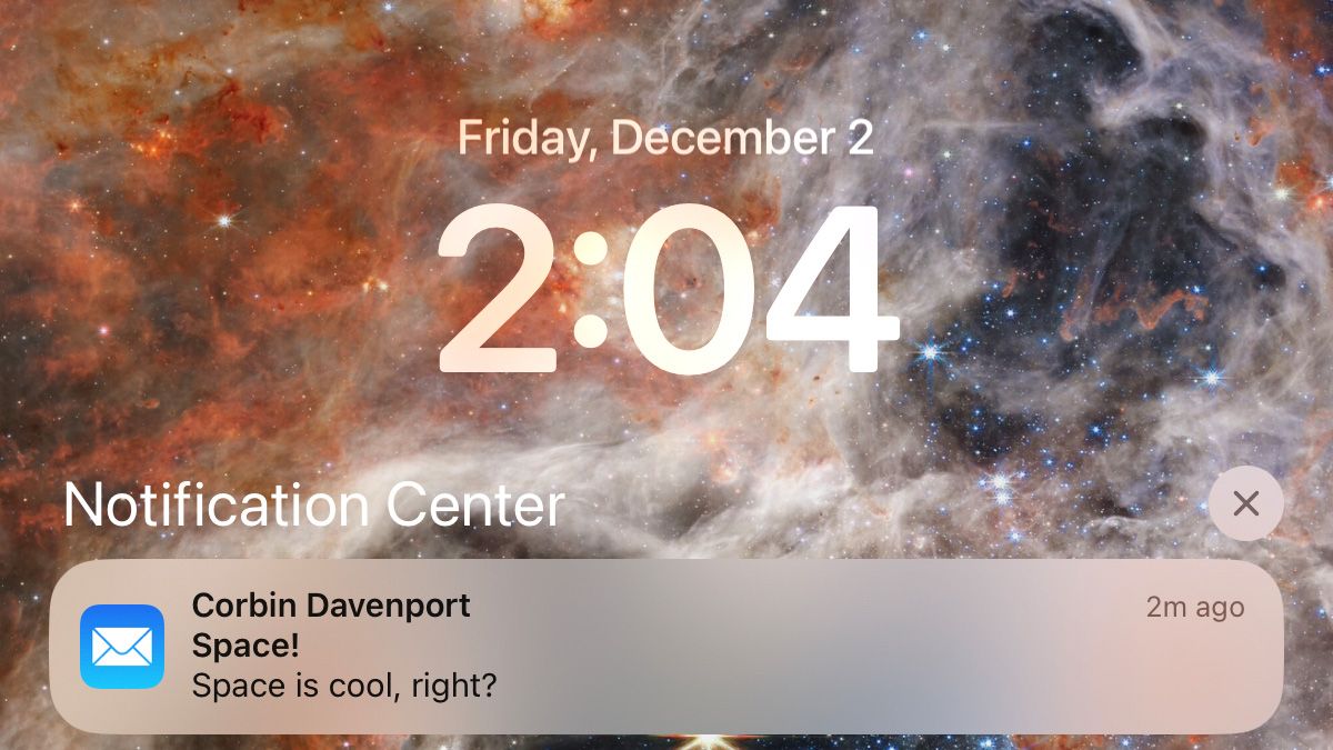 Screenshot of an iPad lock screen with a space wallpaper