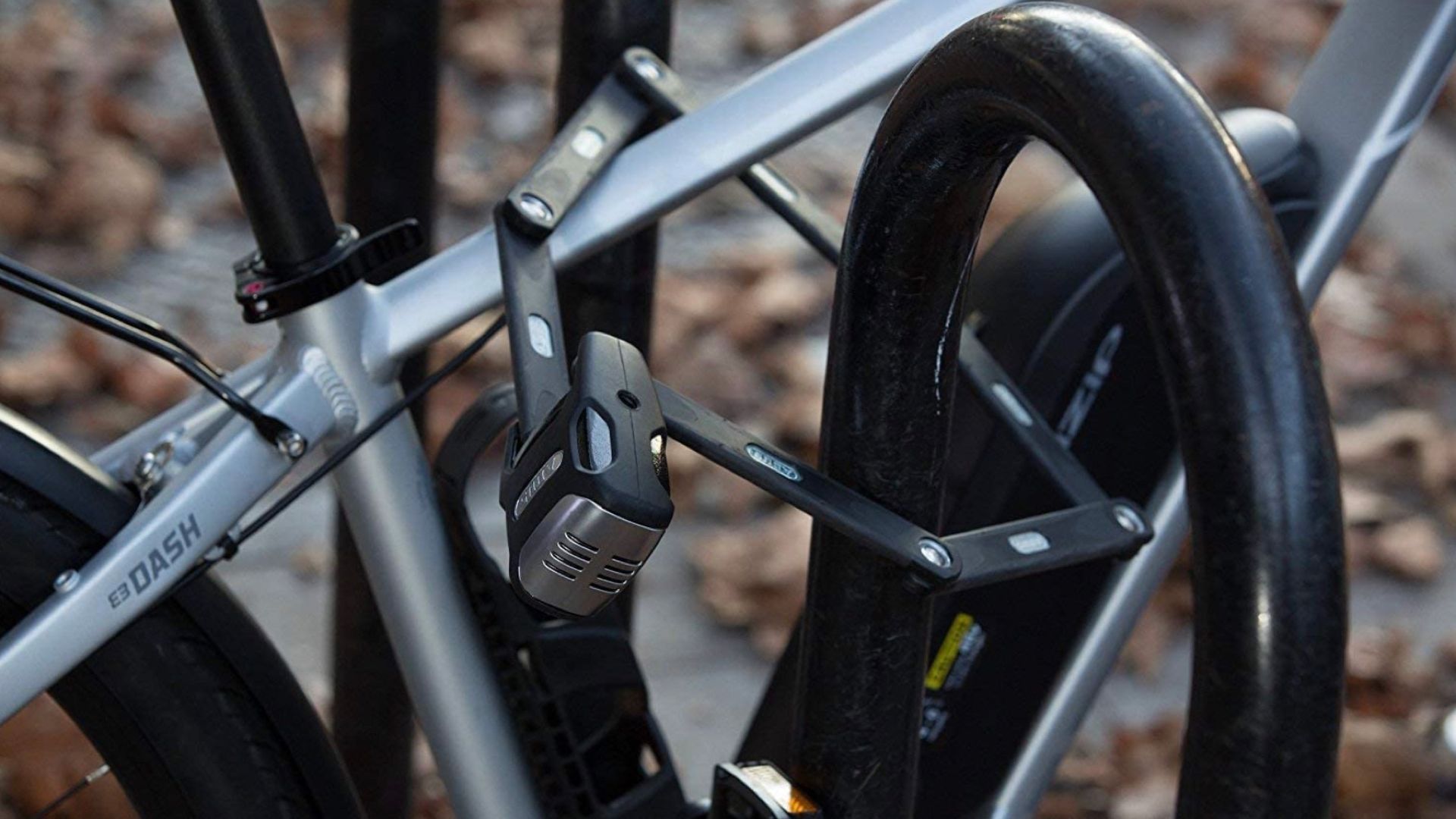 ABUS folding bike lock attached to a bike rack.