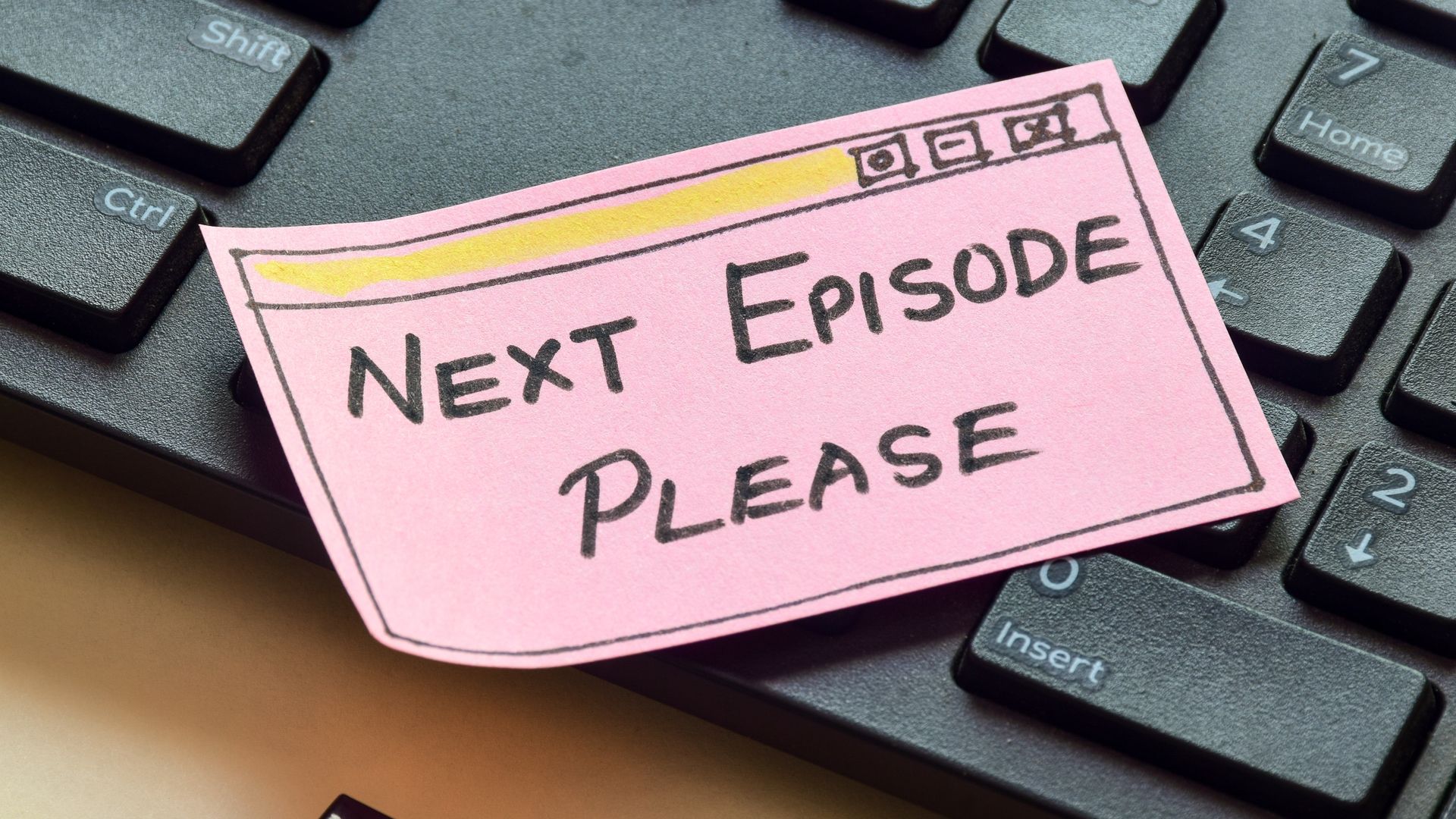 Handwritten note &quot;Next Episode Please&quot; in hand drawn web browser on keyboard.