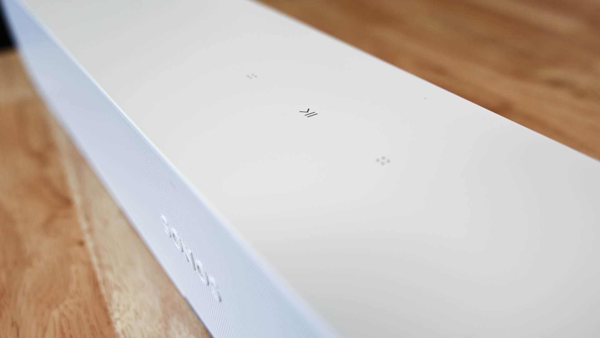 Close up of play buttons on white Sonos Ray soundbar