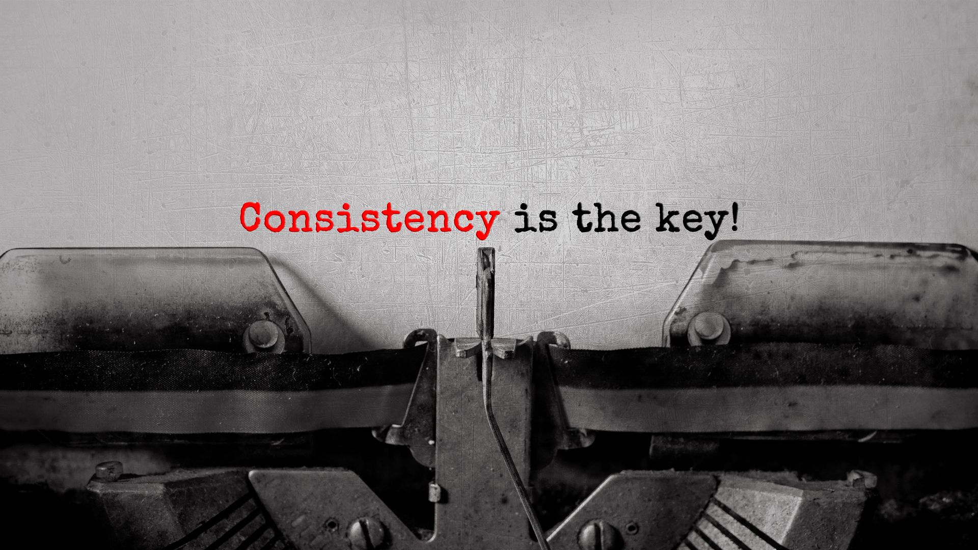 &quot;Consistency is the key!&quot; typed words on a vintage typewriter.