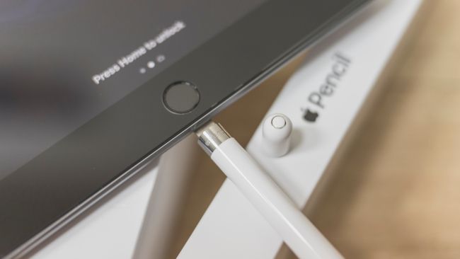 An Apple Pencil being charged with an iPad.