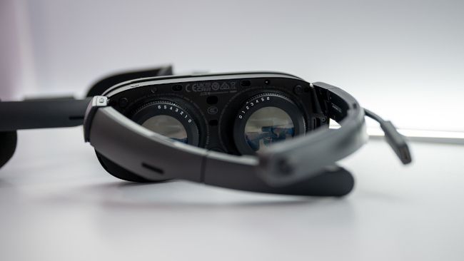 HTC Vive XR Elite in glasses mode focused on lens adjustment knobs.
