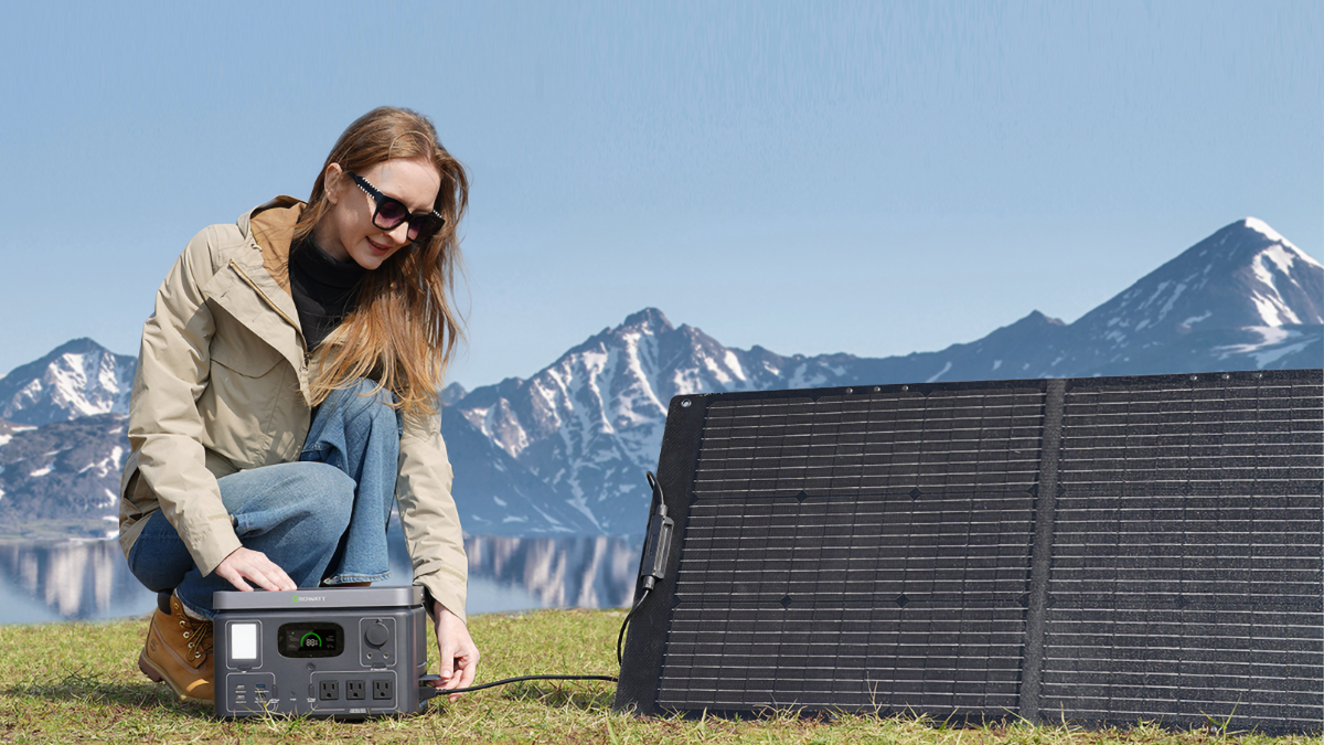 Girl plugging a solar panel into a Growatt VITA 550