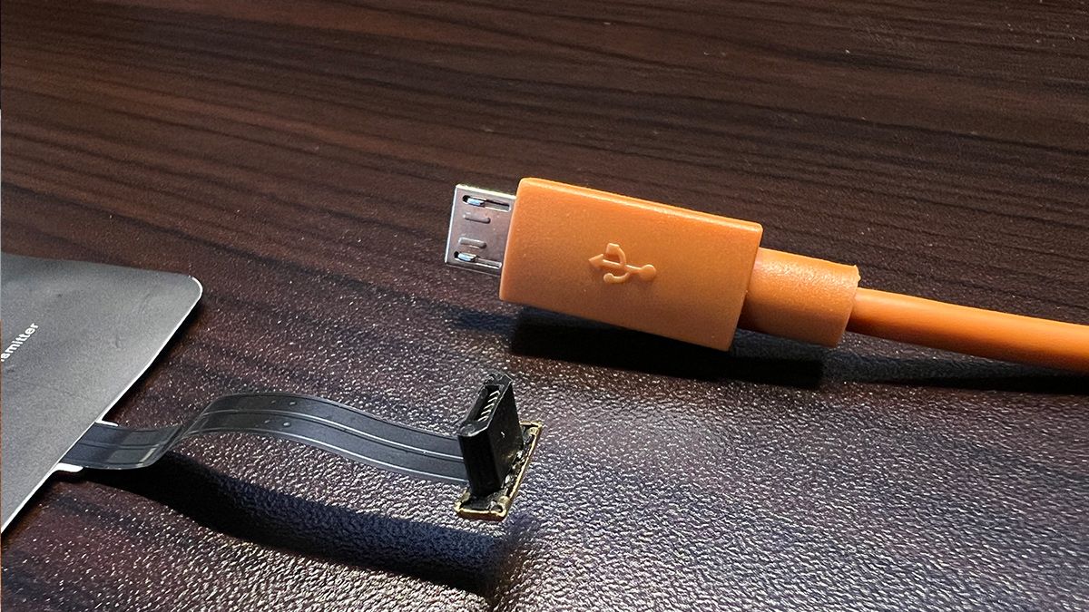 A wireless charger adapter plug compared to a regular micro USB plug.