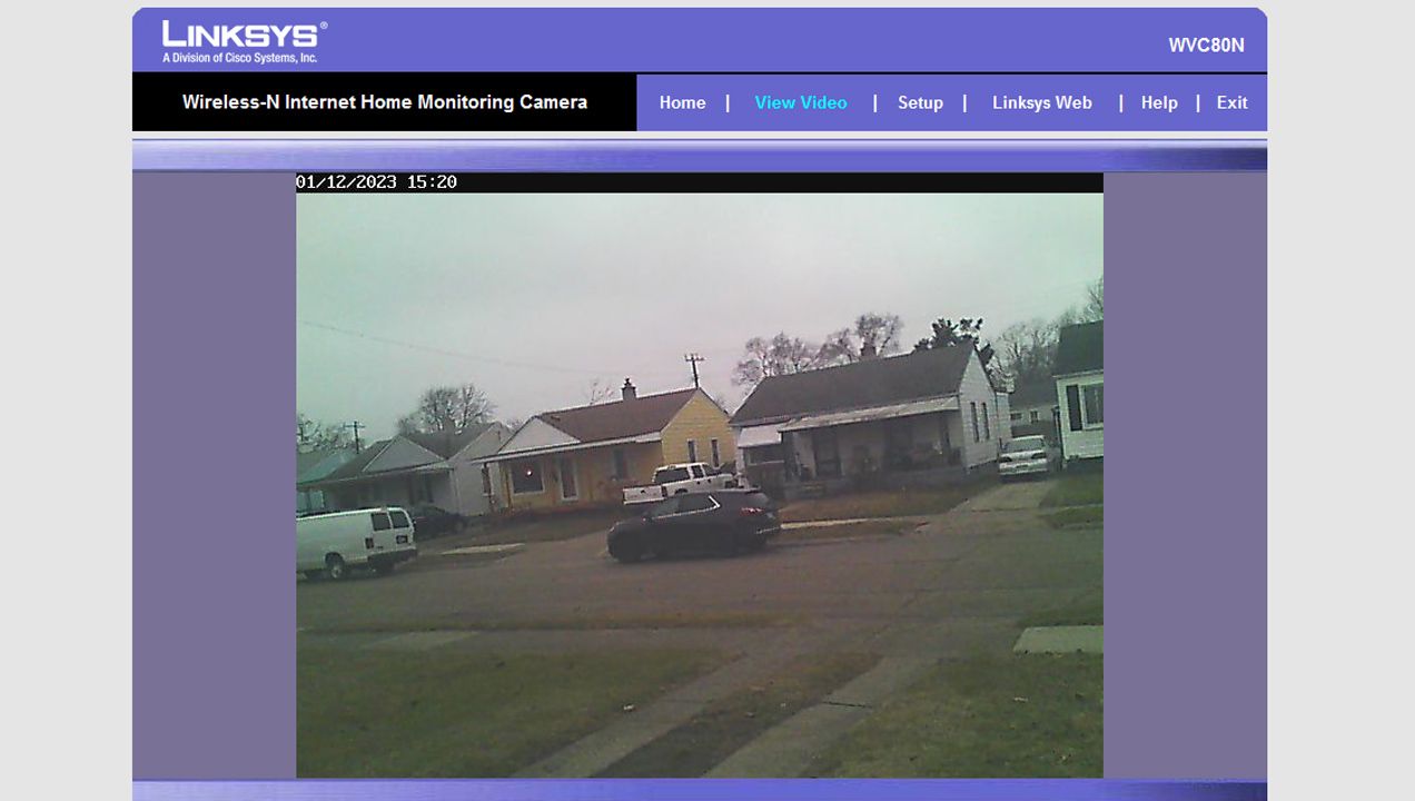 A screenshot of an unsecured Wi-Fi security camera showing a front yard and street view.
