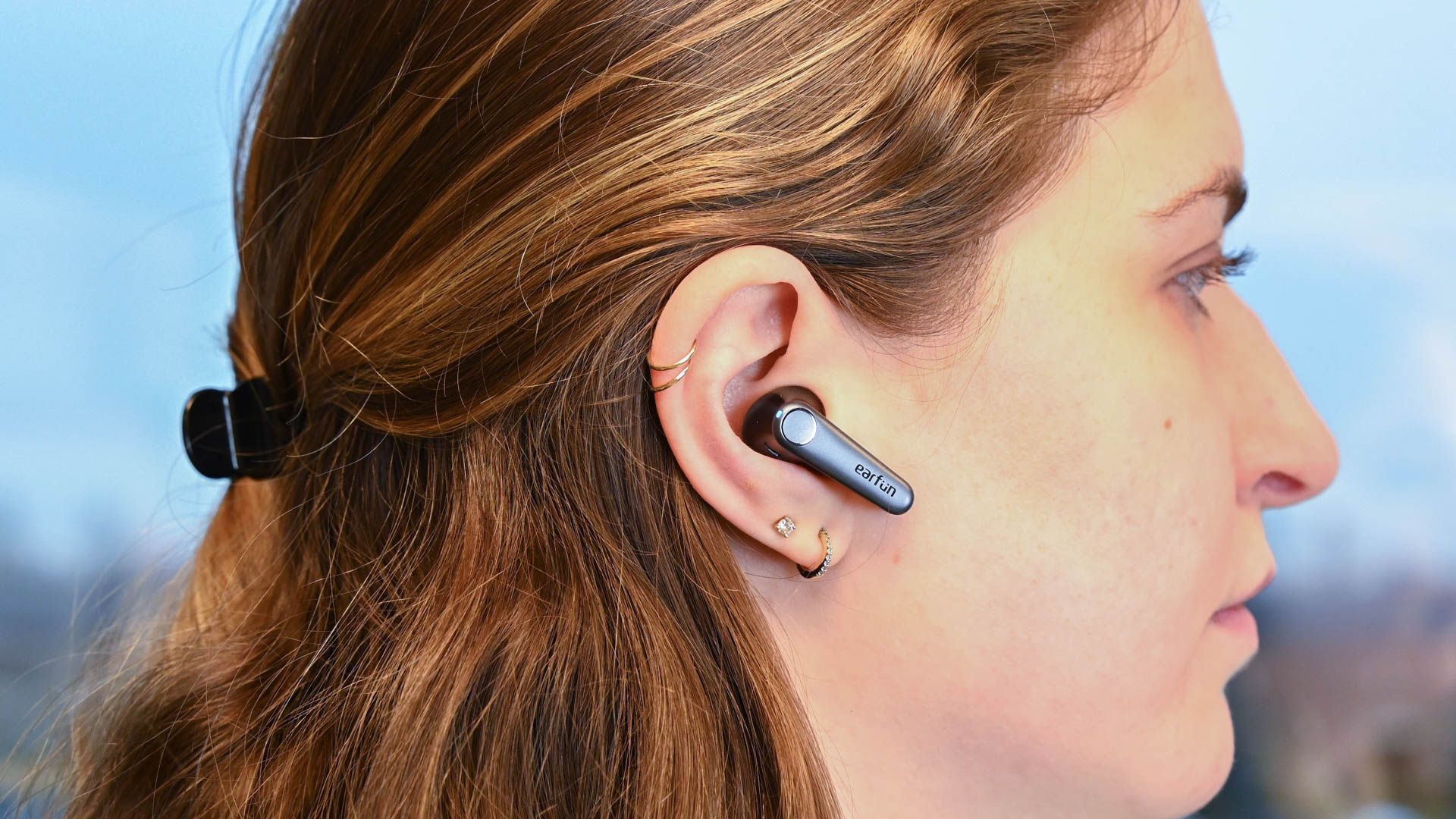 Person wearing a pair of EarFun Air Pro 3 earbuds