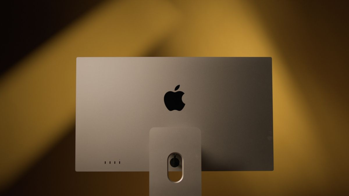 Back of an Apple Studio Display against a yellow background.