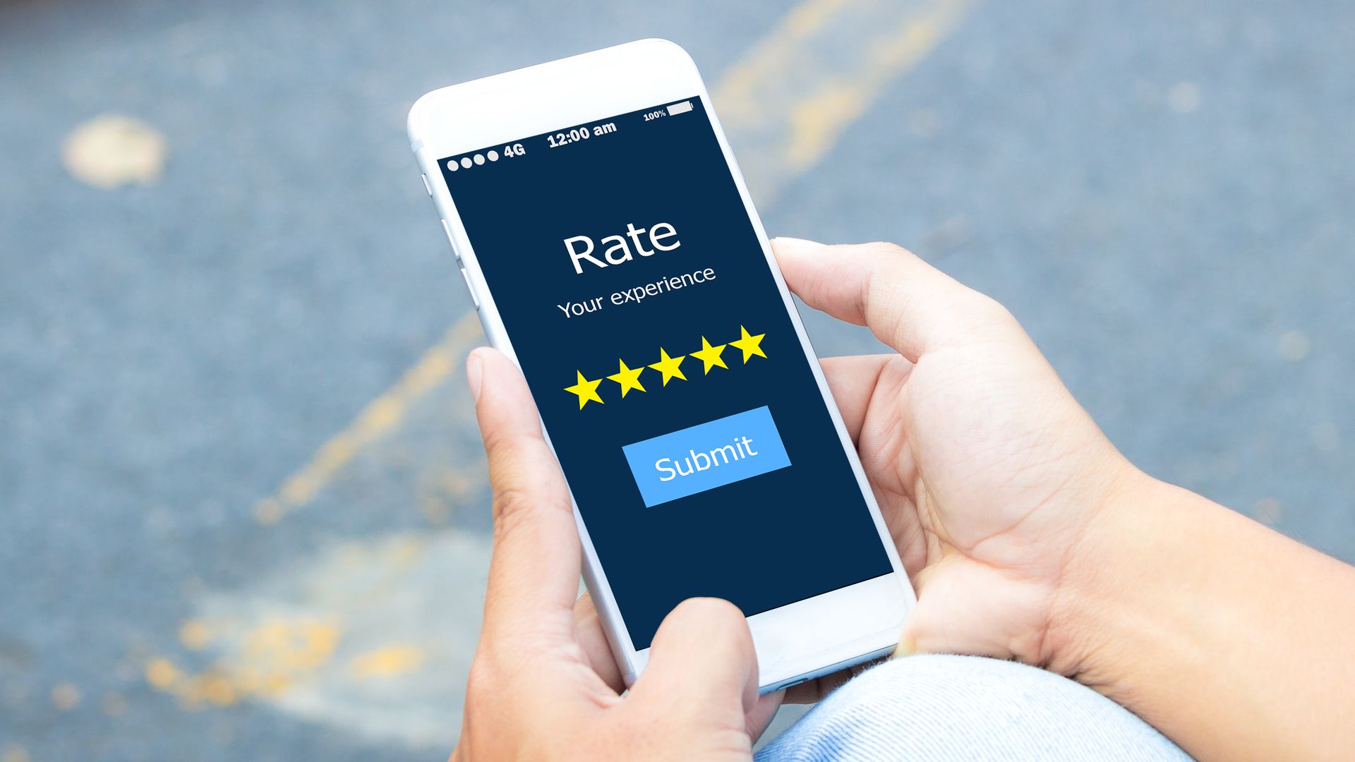 Man hands holding smart phone with &quot;rate your experience&quot; prompt open.