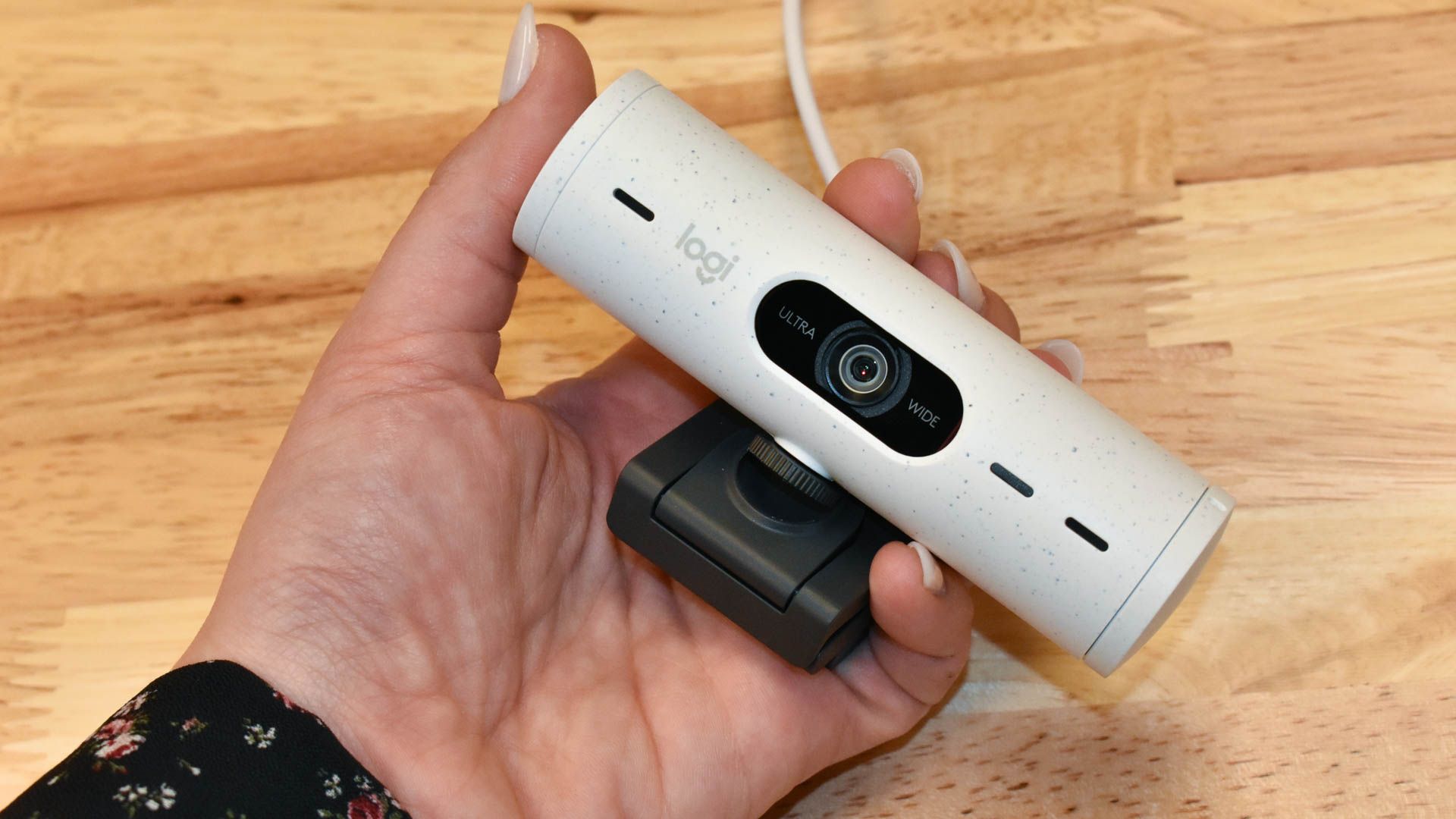 Logitech Brio 500 webcam in hand