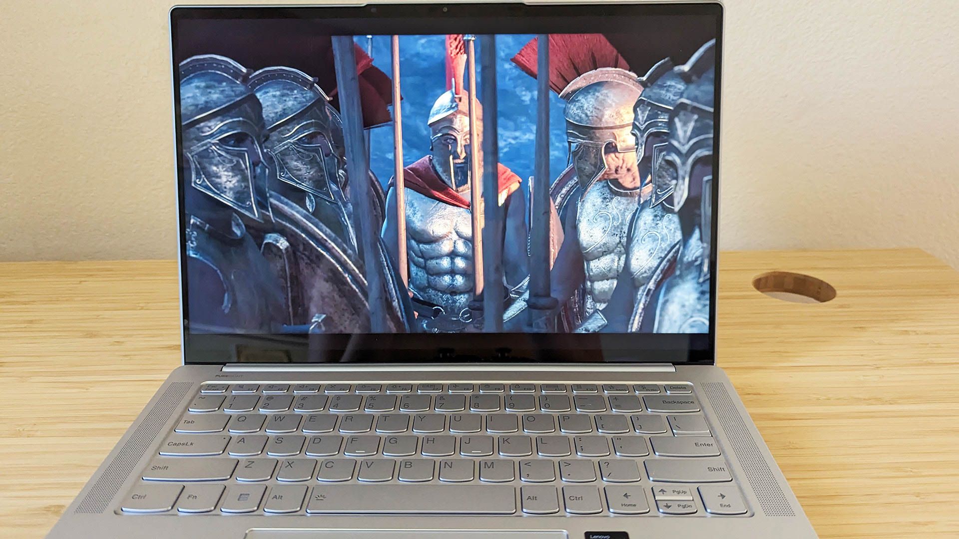 The Lenovo Slim 7i Pro X laptop with a game graphic on screen