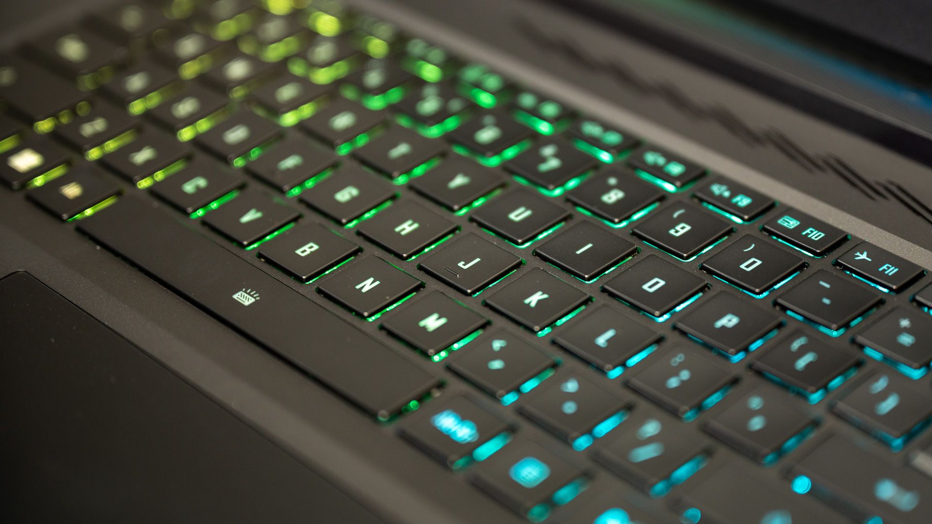 Close up of a green and yellow gaming laptop RGB keyboard