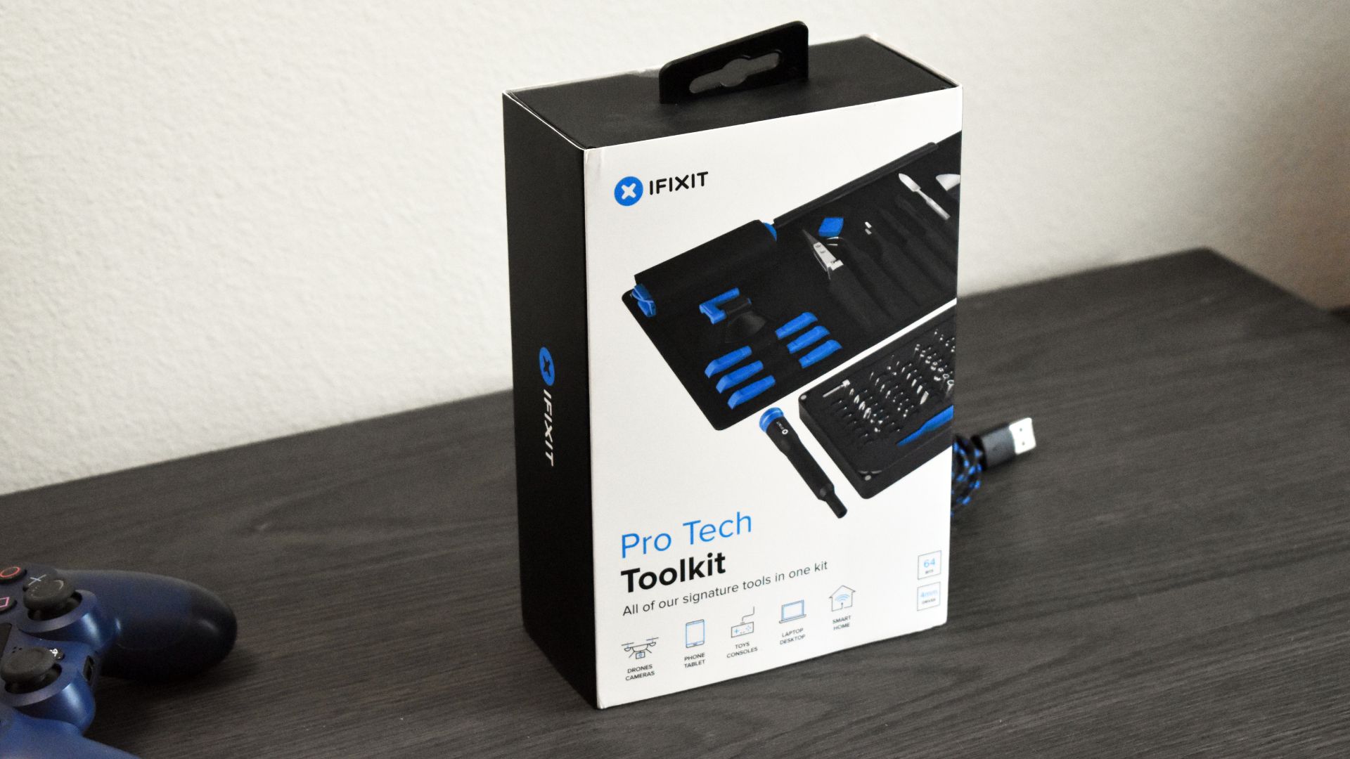 iFixit Pro Tech Toolkit on mantle next to PS4 controller