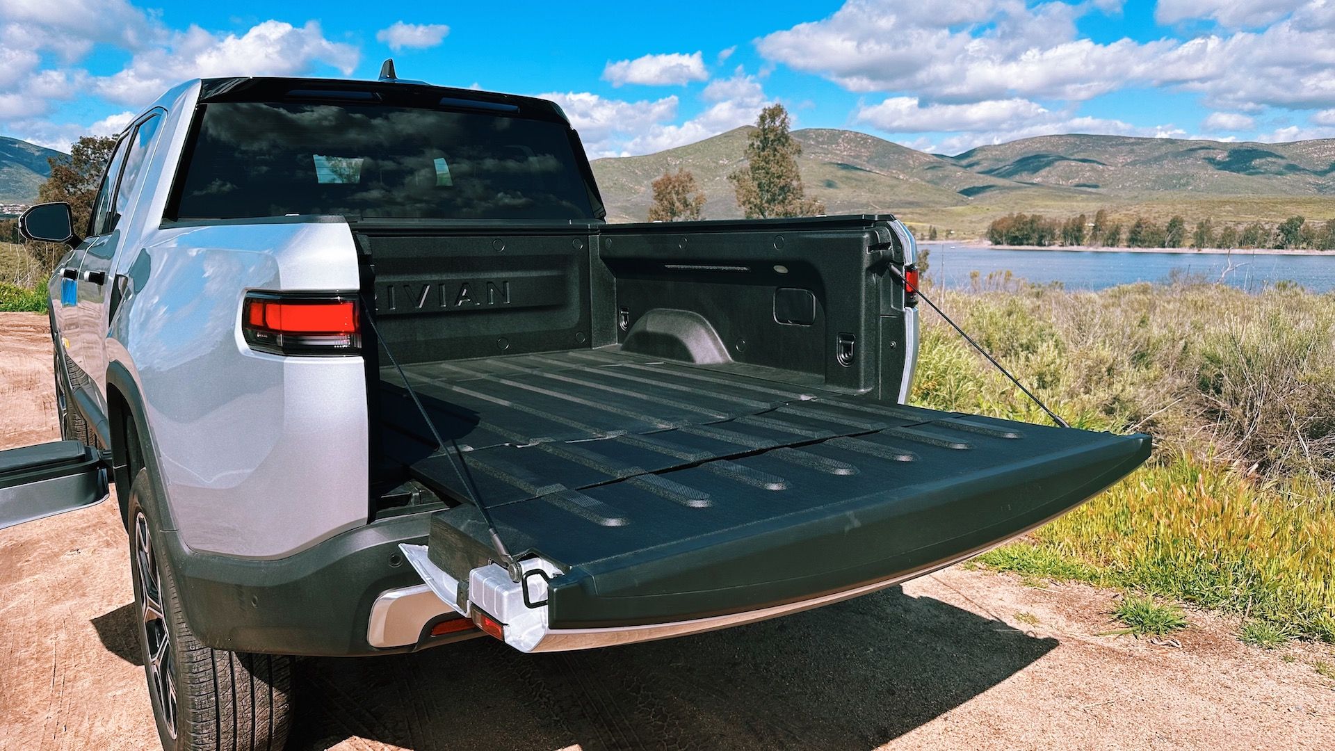 The truck bed of Rivian R1T open empty