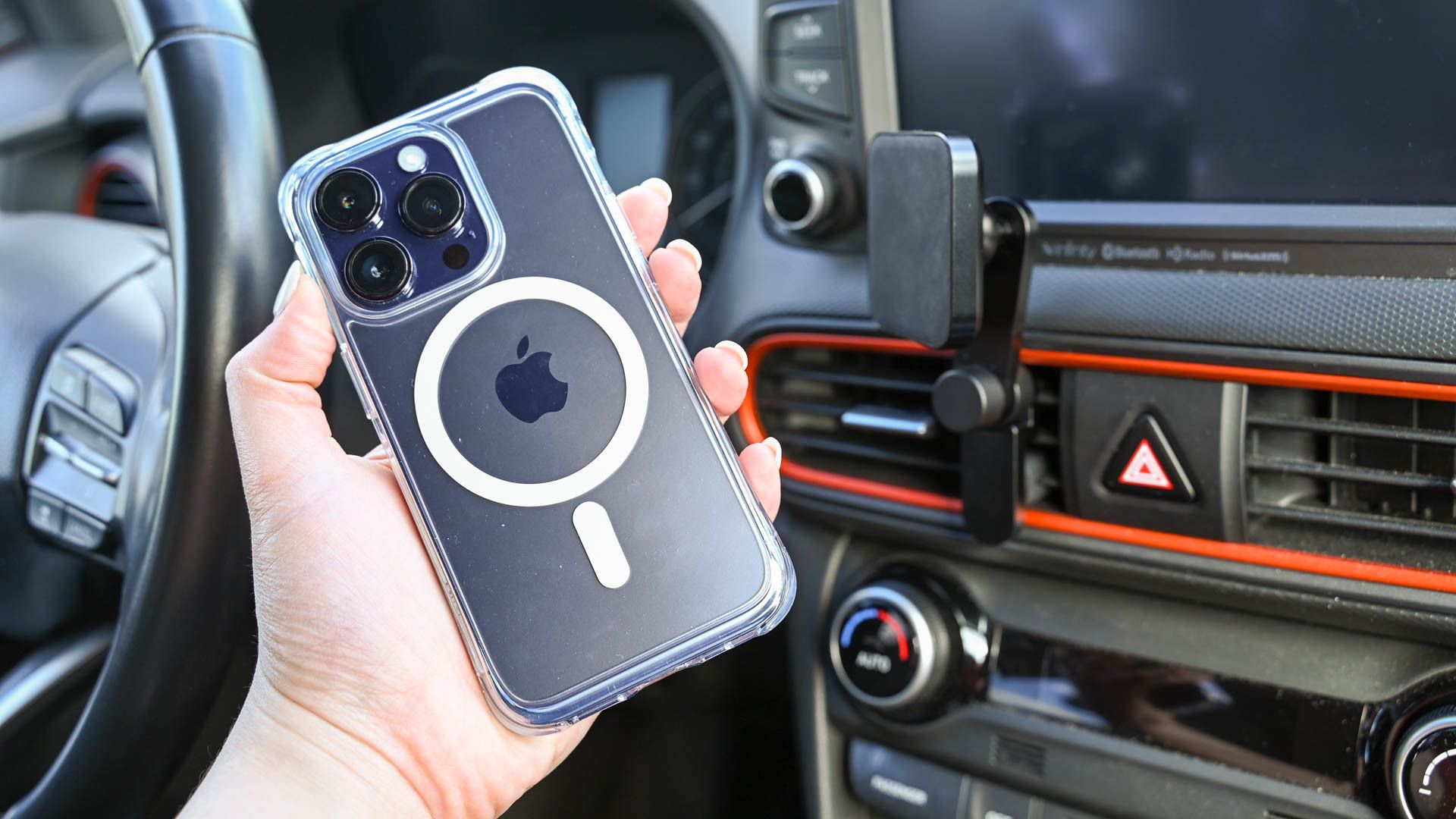 Person holding phone and mounting to Peak Design Car vent mount.