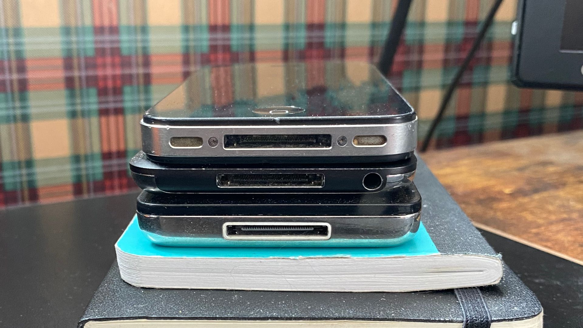 Three Apple devices that use the 30-pin connector stacked up.