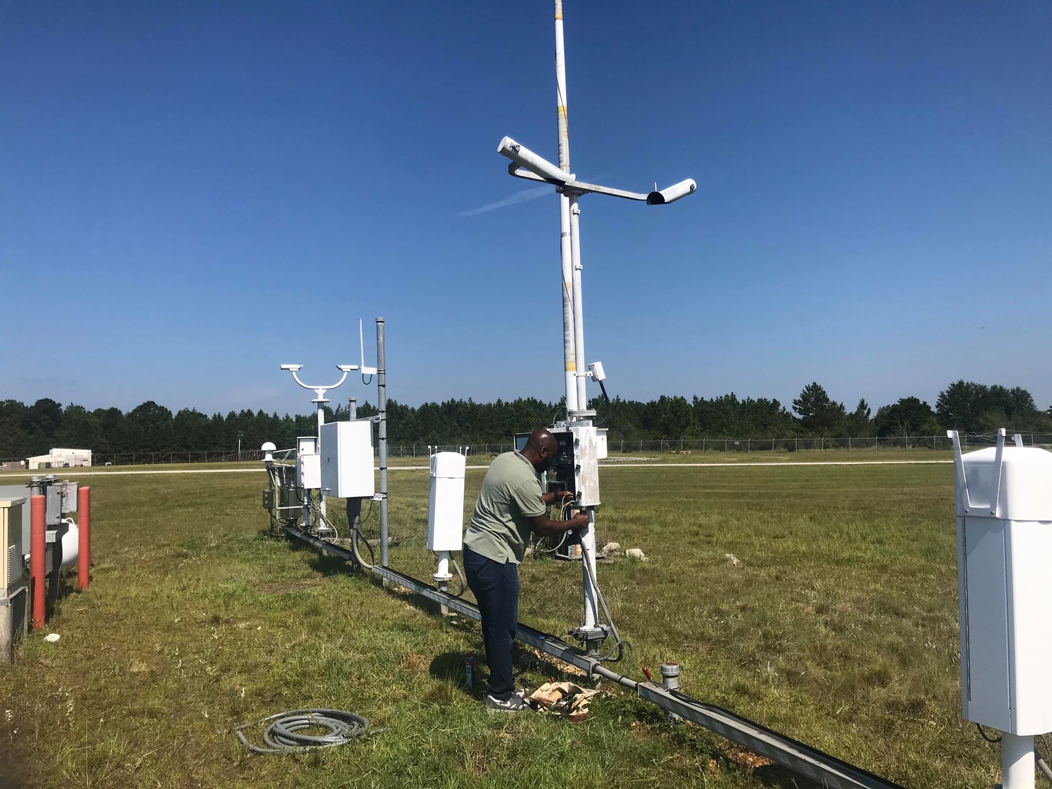 Photo of a person repairing a weather station