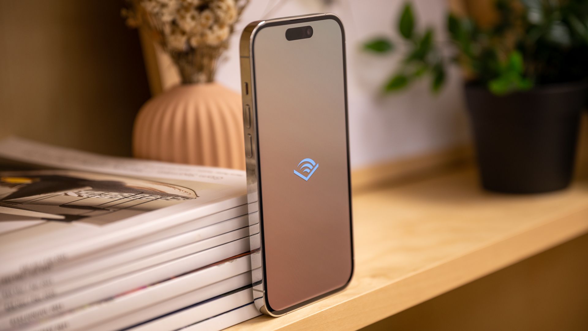 Left side of the Apple iPhone 14 Pro with the audible logo on the screen.
