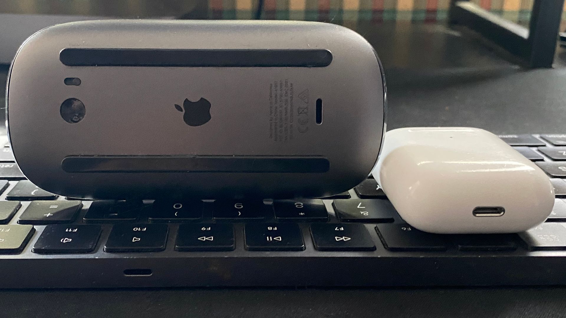 A keyboard, mouse, and AirPods that charge via Lightning.