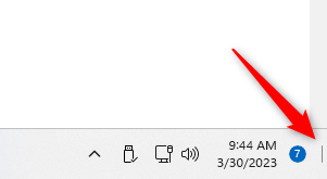 Click the "Show Desktop" button in the Windows 11 taskbar.