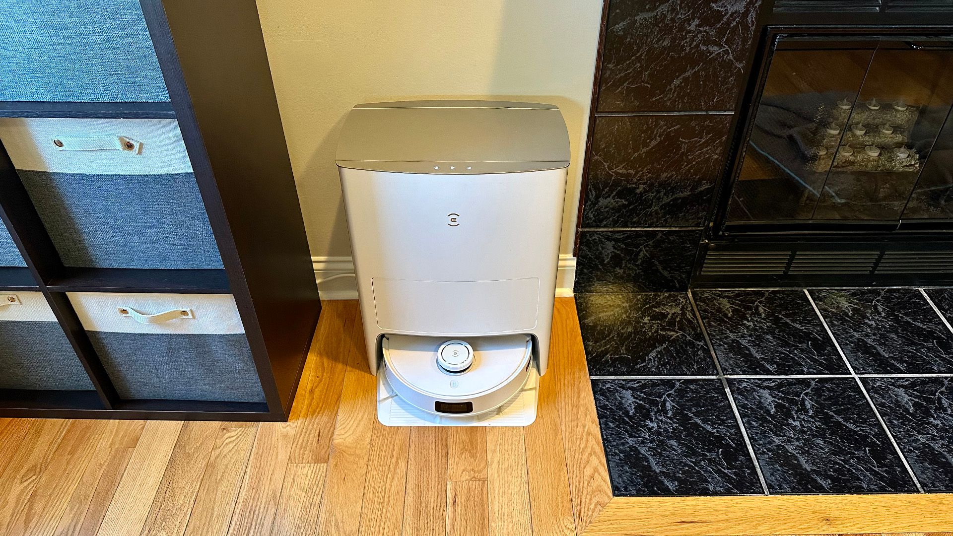 DEEBOT T10 OMNI between a fireplace and storage bins