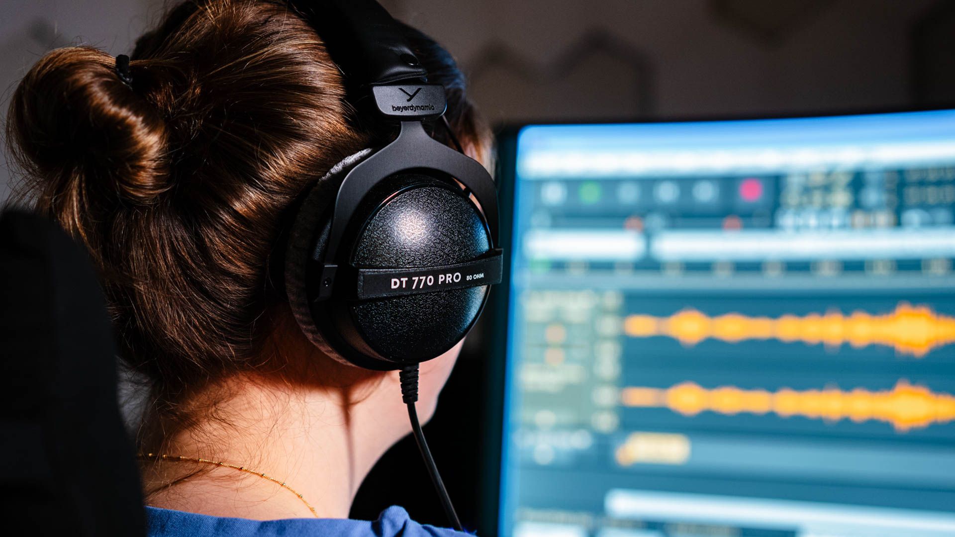 Person editing music using the Beyerdynamic DT 770 PRO